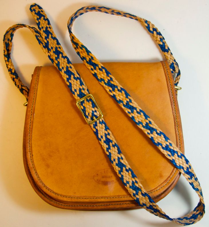 Small purse made from kangaroo leather with braided strap. The braiding for this bag has roots in Australia.