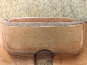 Start by forming the leather over a wooden form